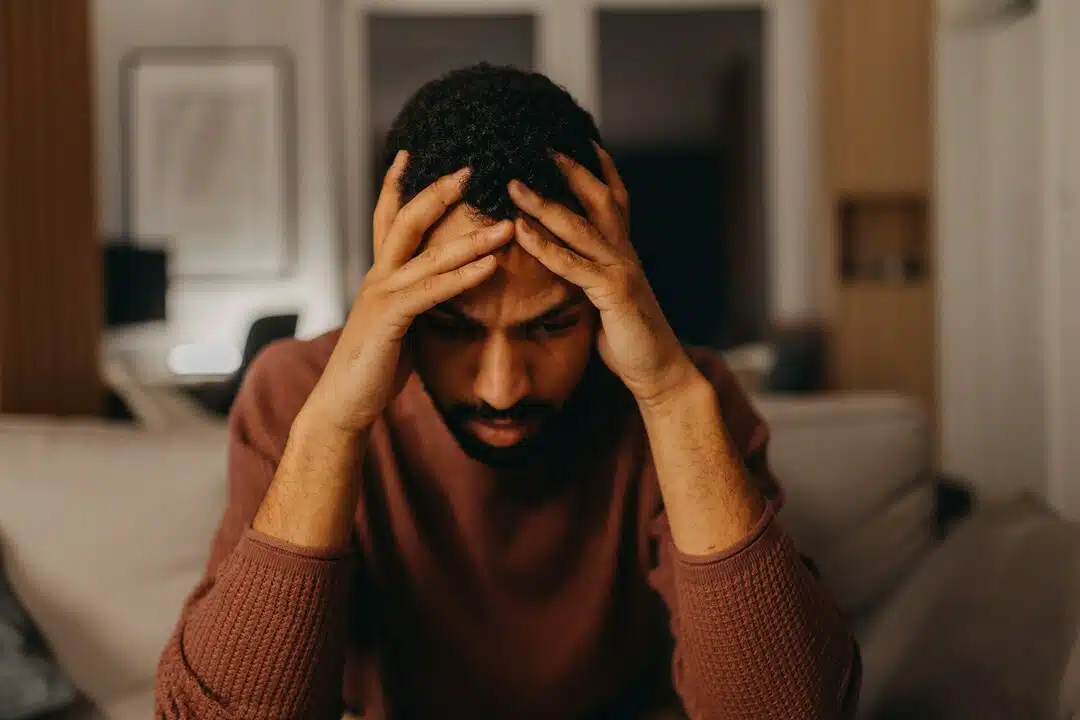 A man looking stressed at home