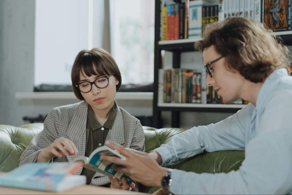A man and woman reading a book
