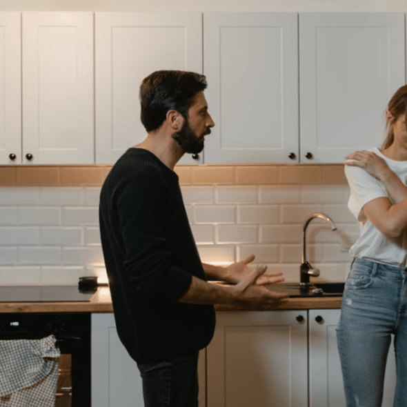 A man yelling at his wife in the kitchen