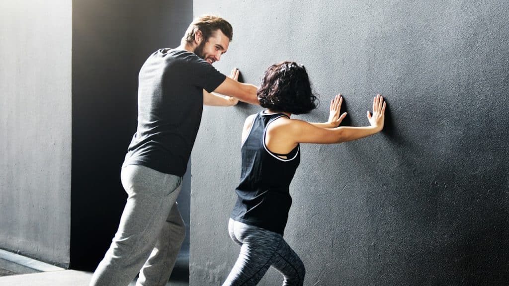 A man and a woman working out together.