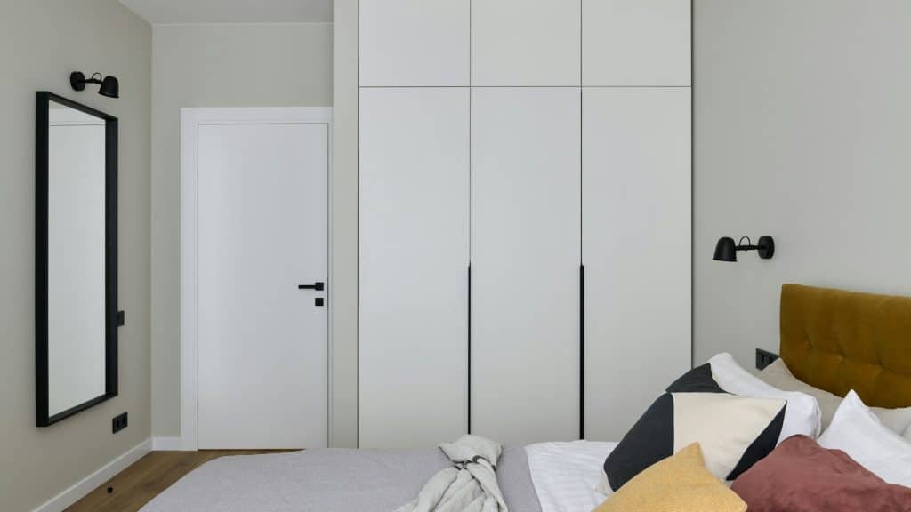 A bedroom with white walls.