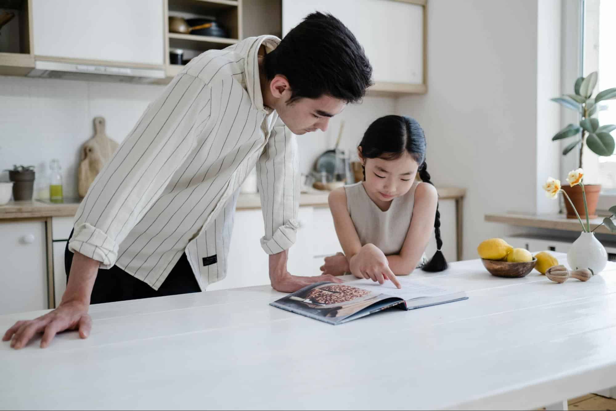 A man guiding their daughter