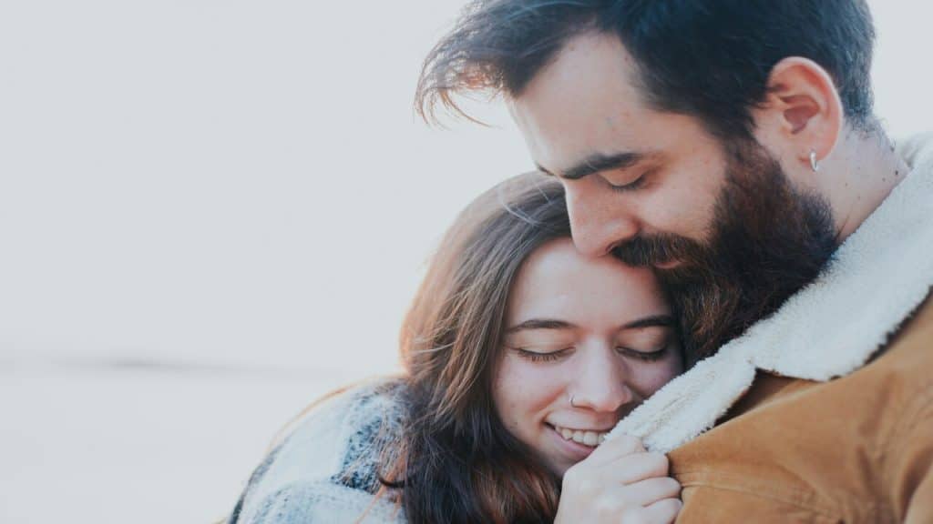 A couple hugging outdoors