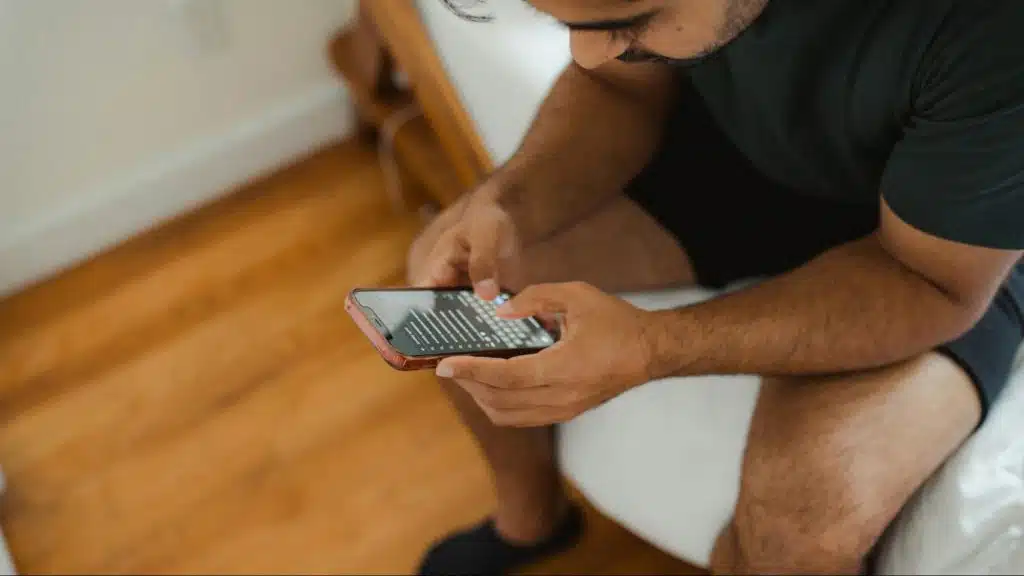 A man at the bed while using a phone
