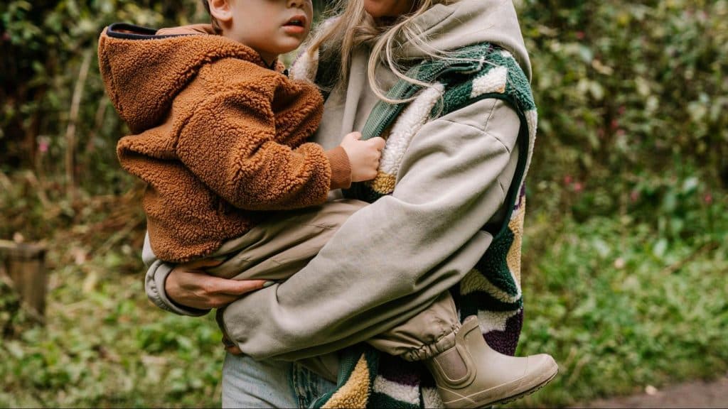 A woman carrying a child