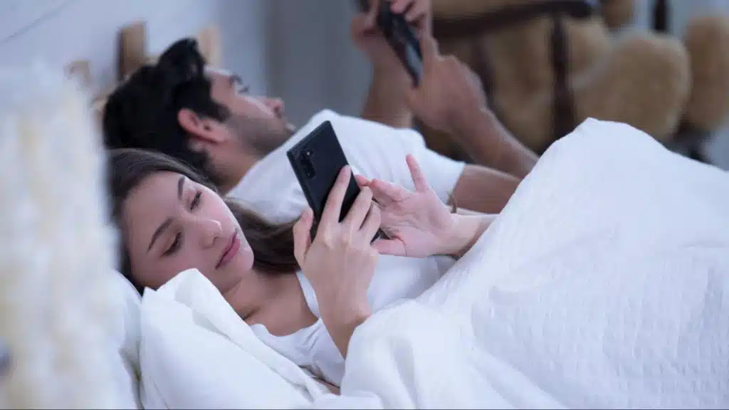 A man and woman using a phone