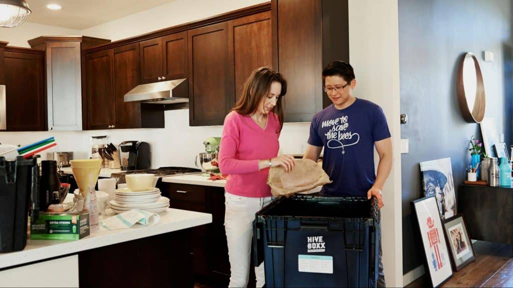 A man and woman cleaning the house