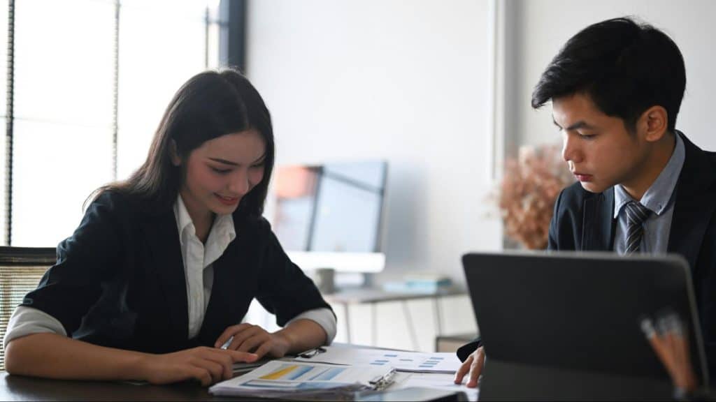 A man looking at the woman’s work 