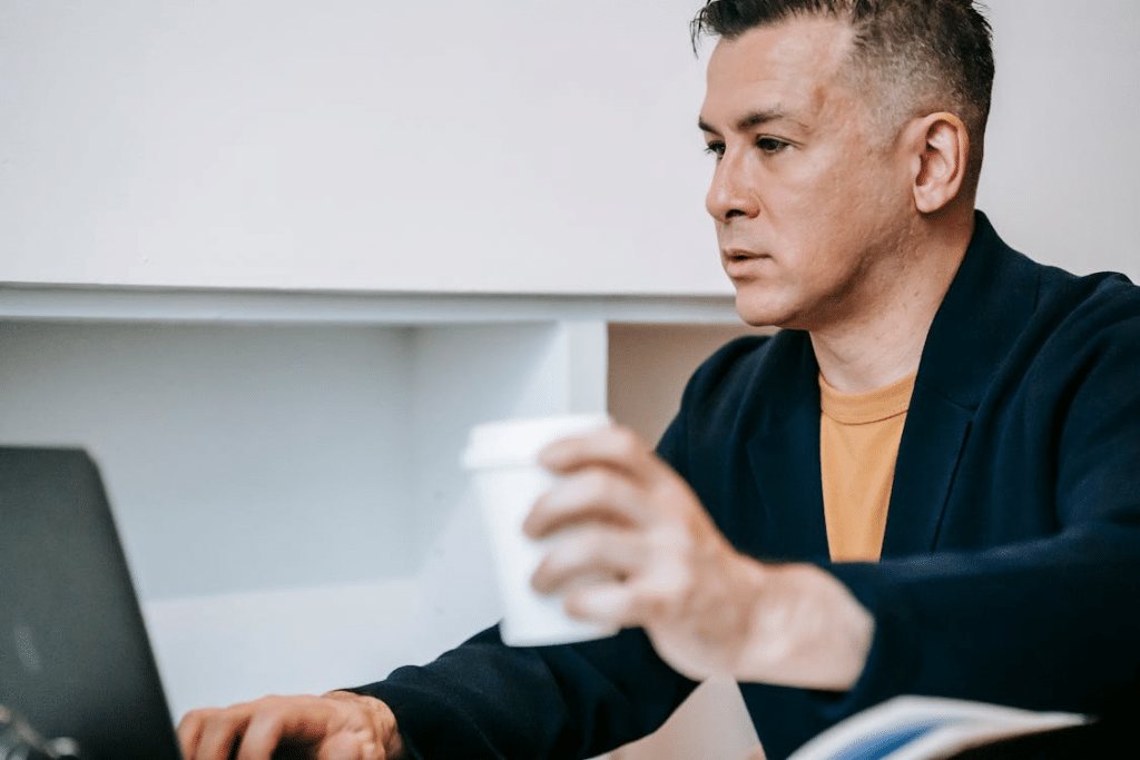 A sad man using a laptop