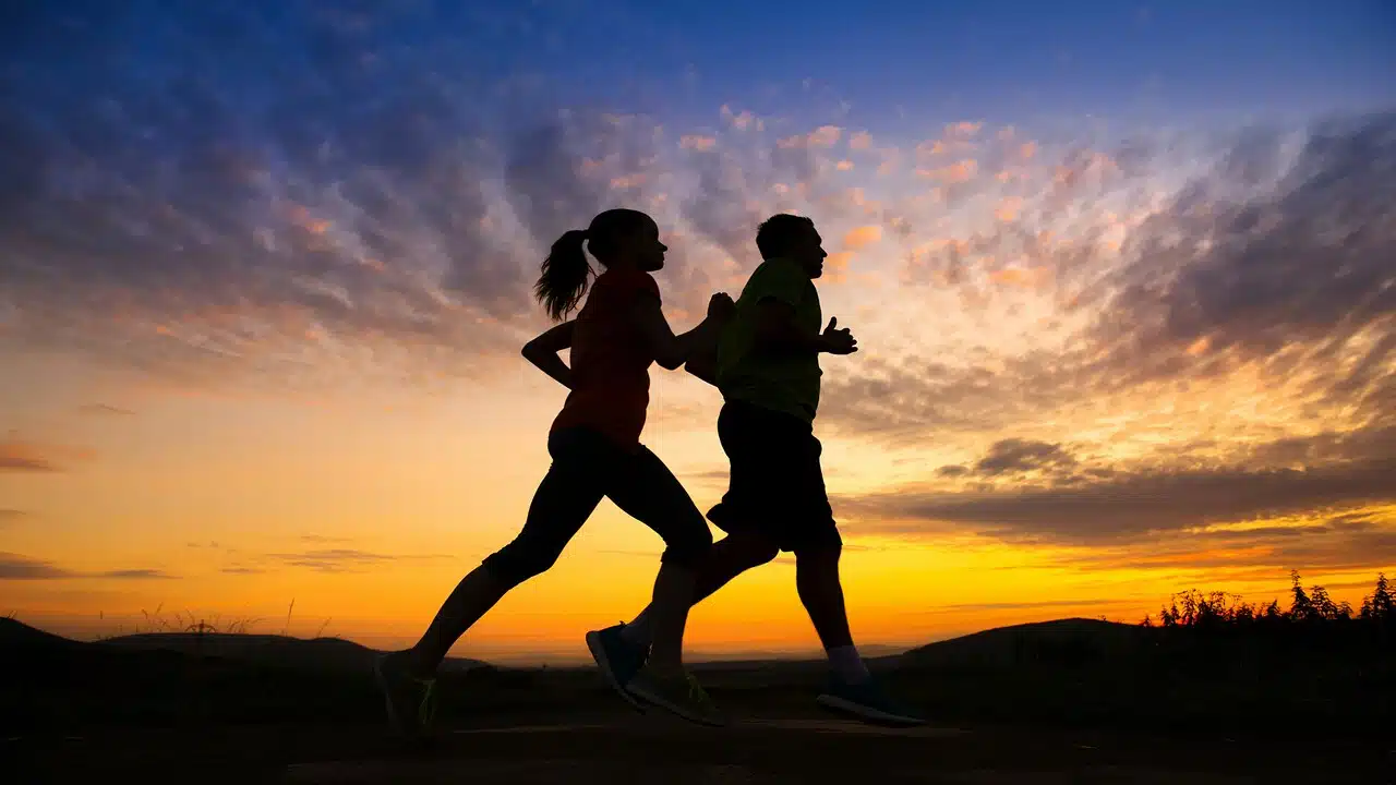 A couple jogging at sunset