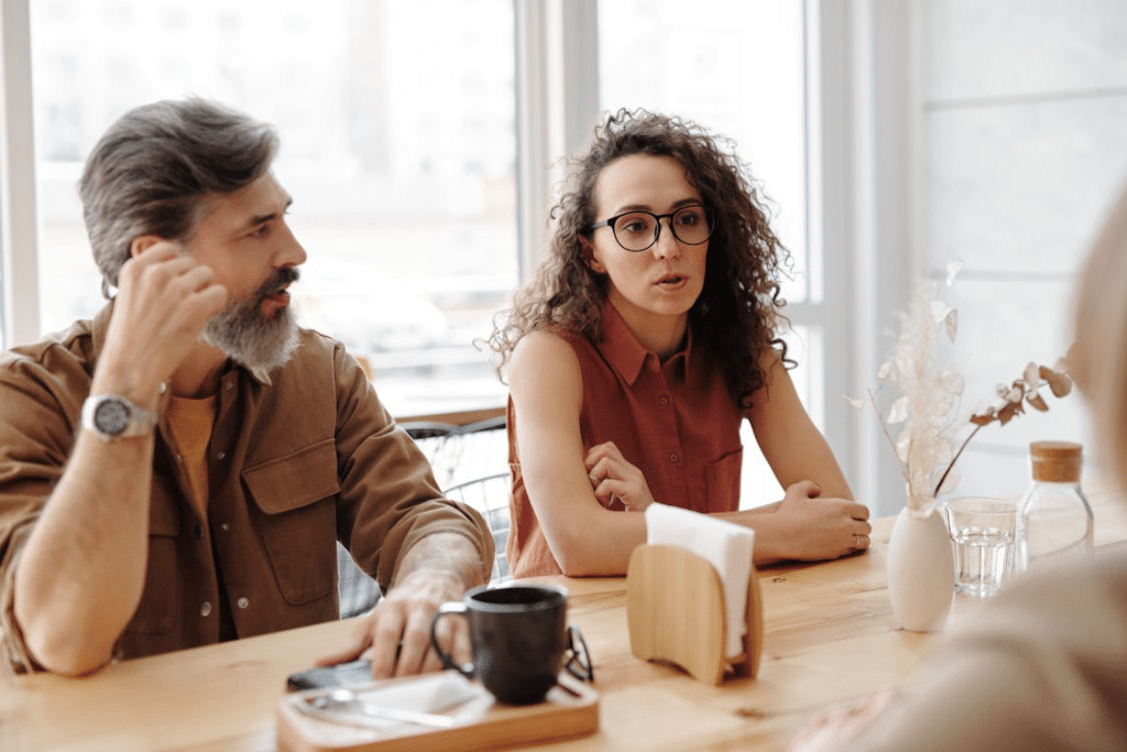 A Man and Woman Sitting at the Table Together Having an Argument