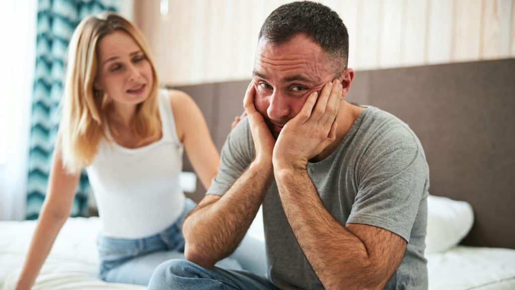 An angry woman complaining to her husband, who is ignoring her.