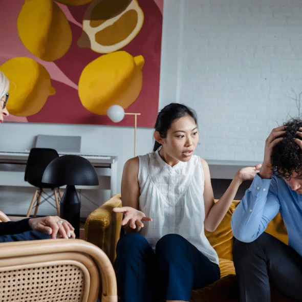 Couple discussing problems during session with psychologist