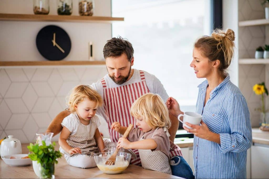 A man teaching their child to cook
