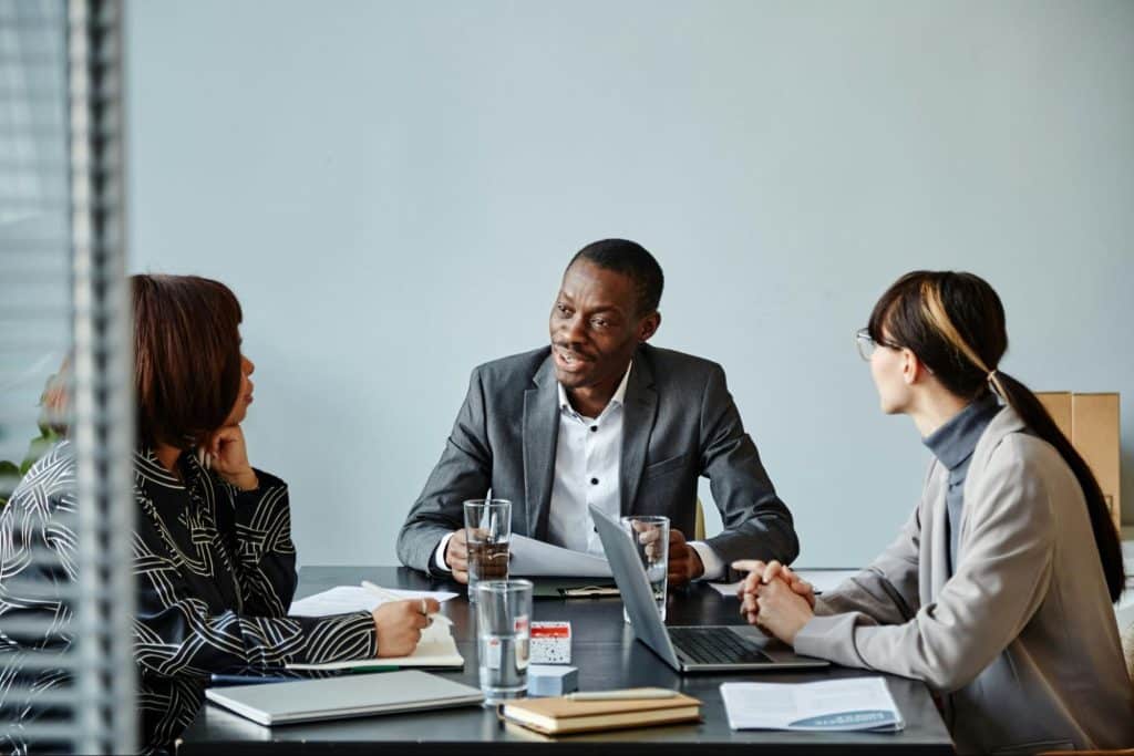 A man talking to his colleagues