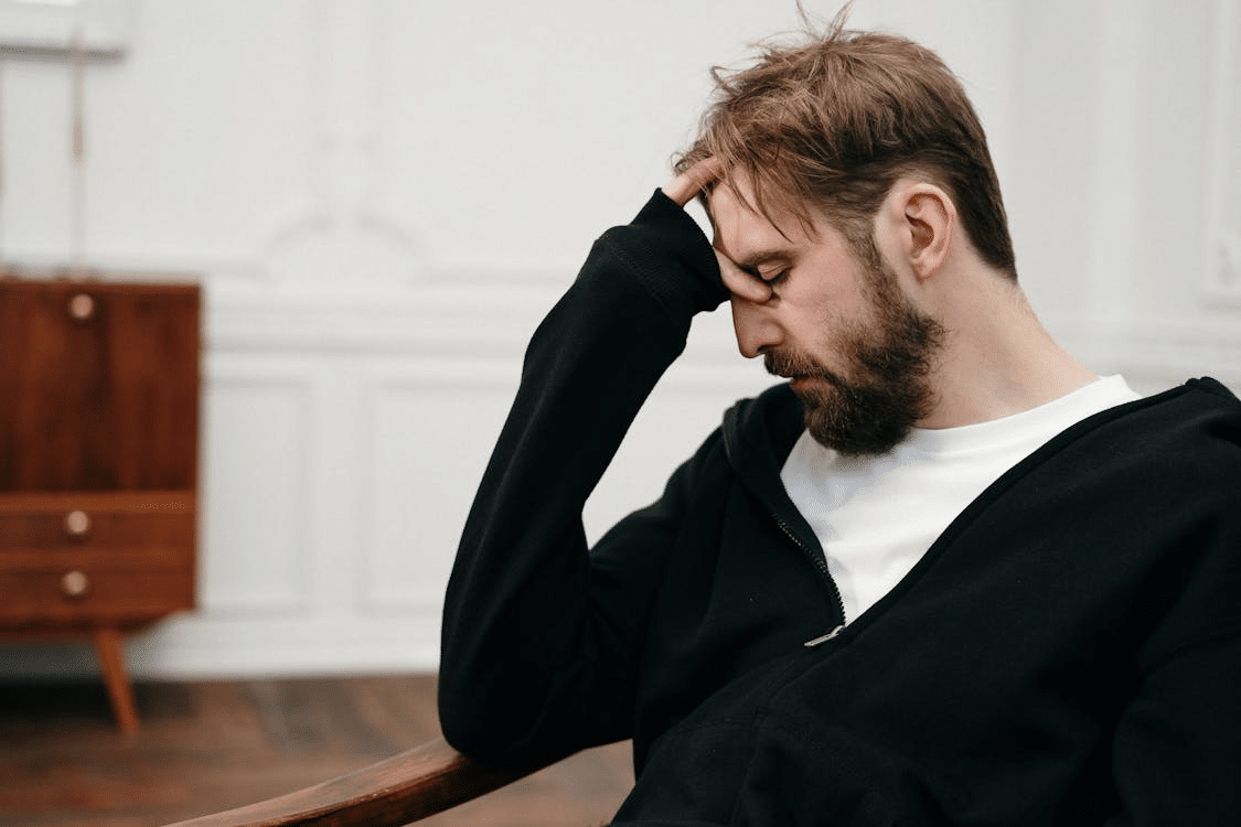 A man holding his head