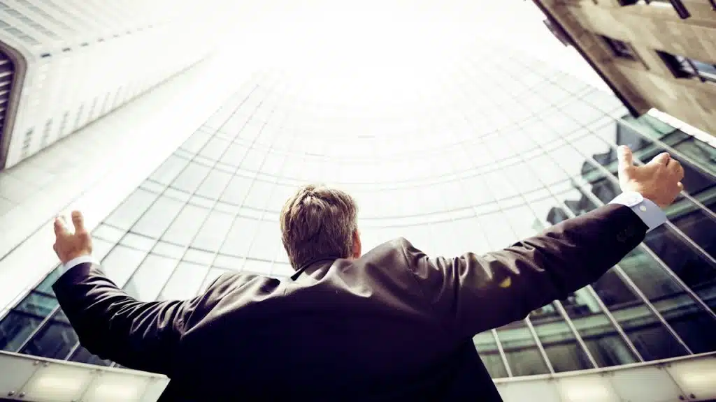 A man wearing a suit in the middle of buildings.