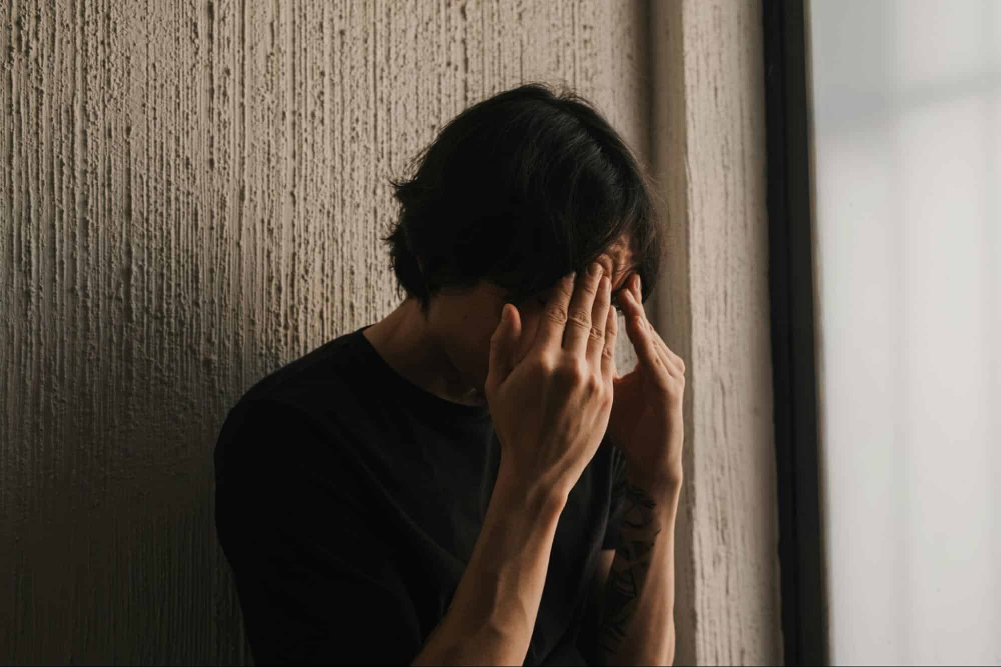 A man holding his head 