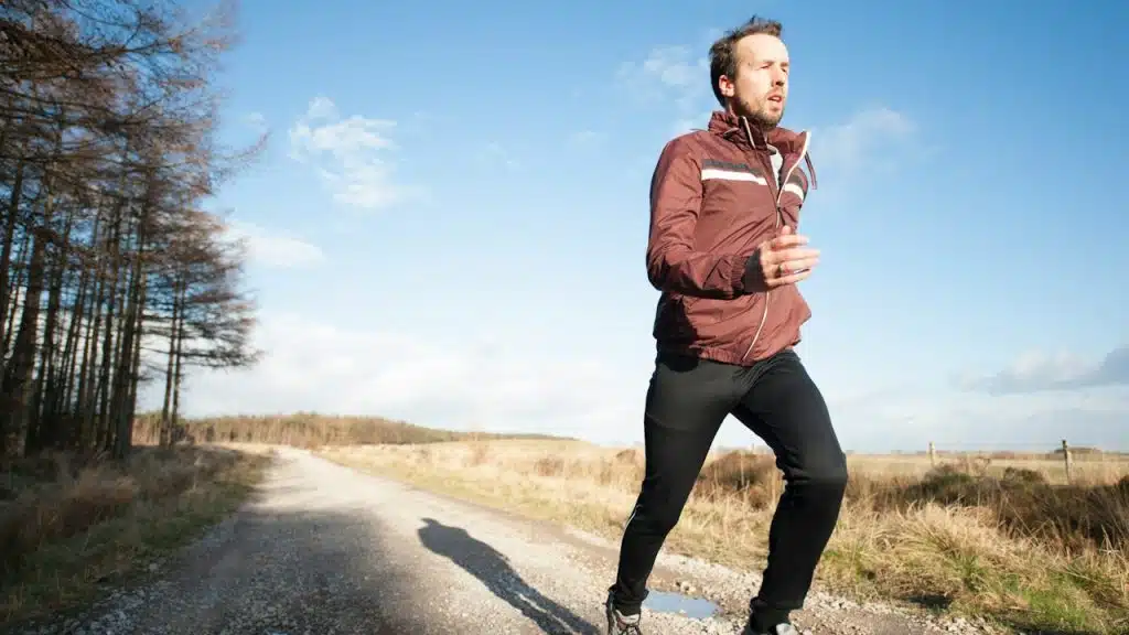 A man running on a runway at daytime.