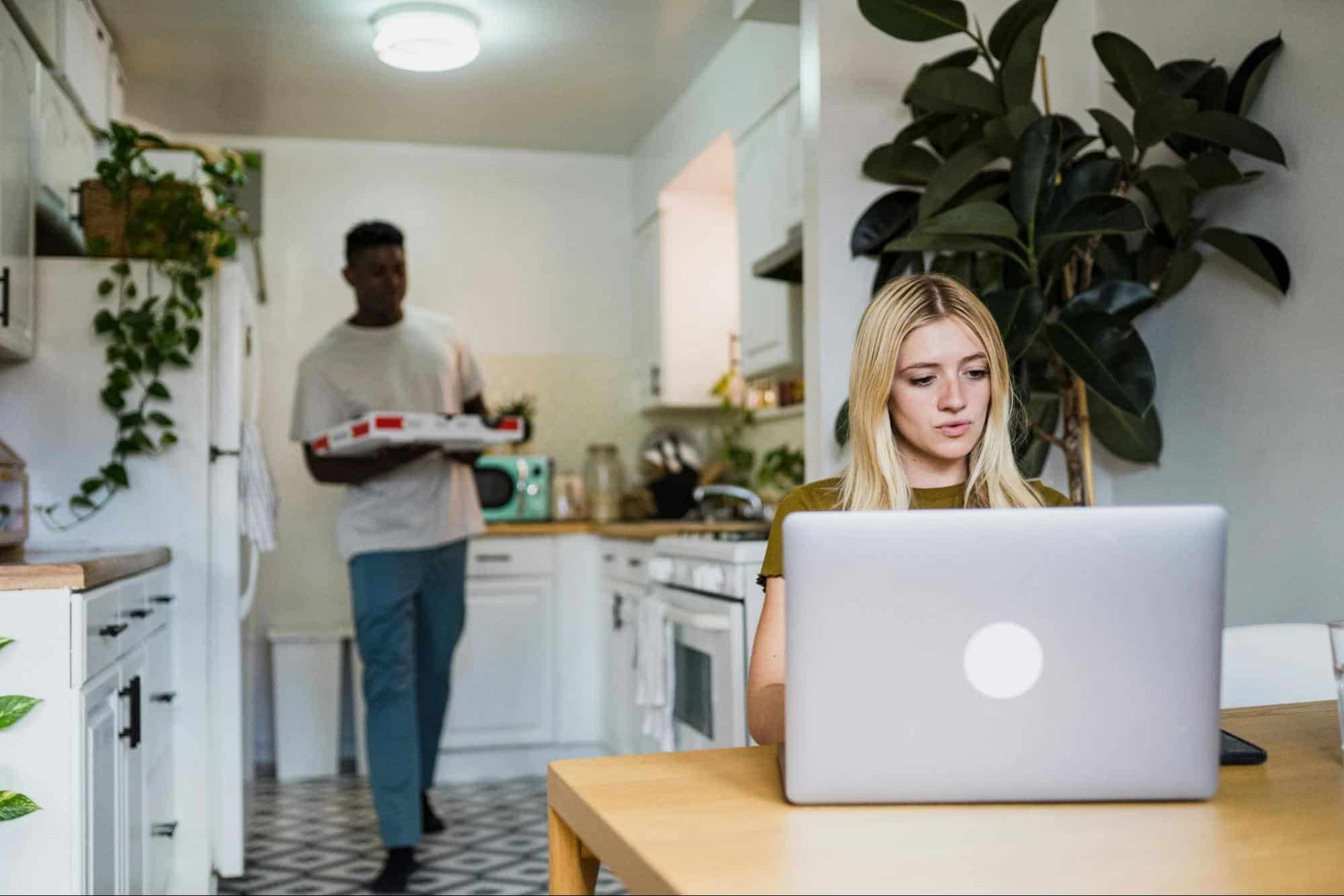 A man bringing a food for a busy woman