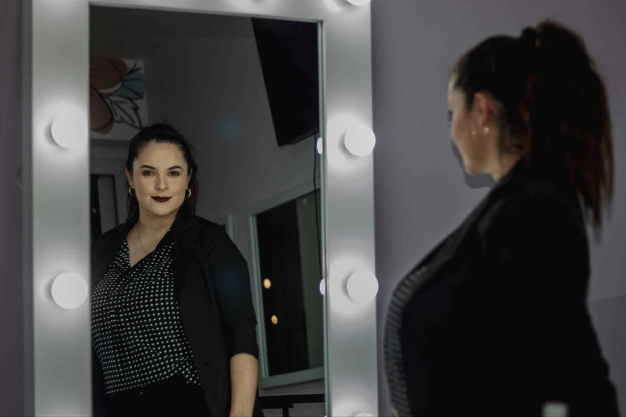 A woman smiling at the mirror