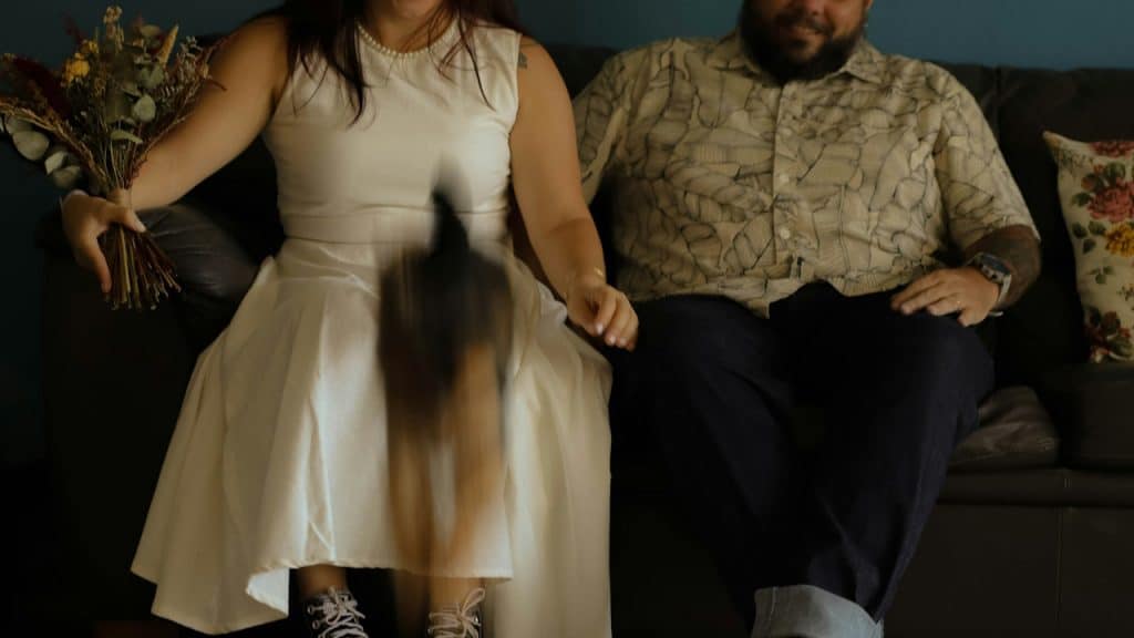 A man and a woman sitting on a couch.