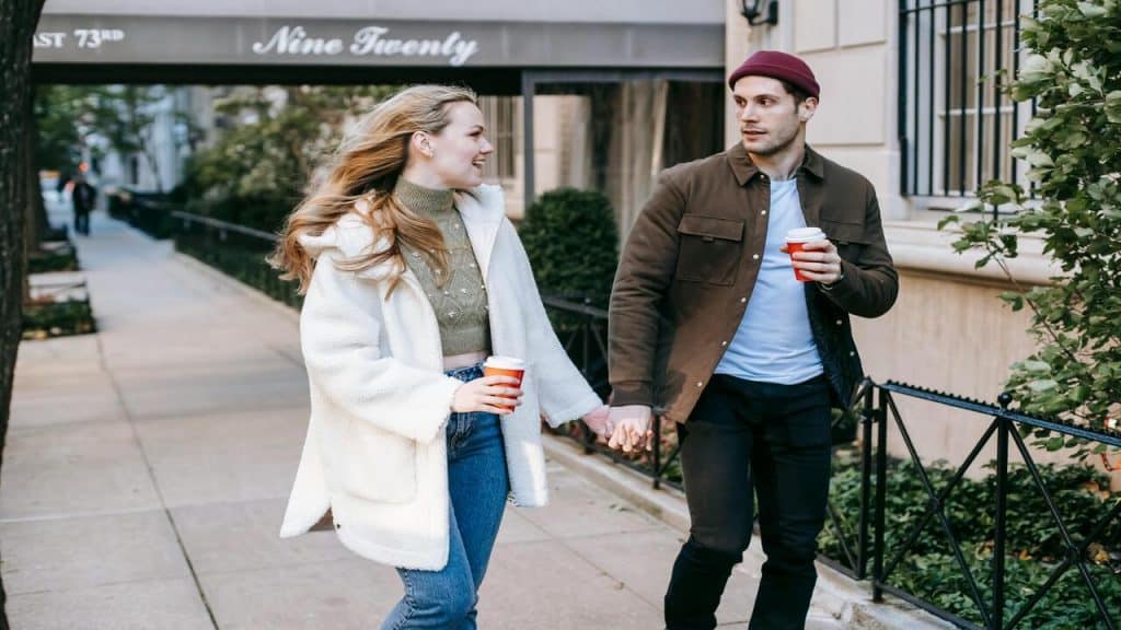 A couple talking on the sidewalk