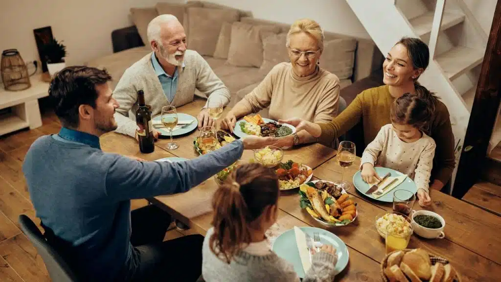 A family gathered around a table sharing a meal at home.