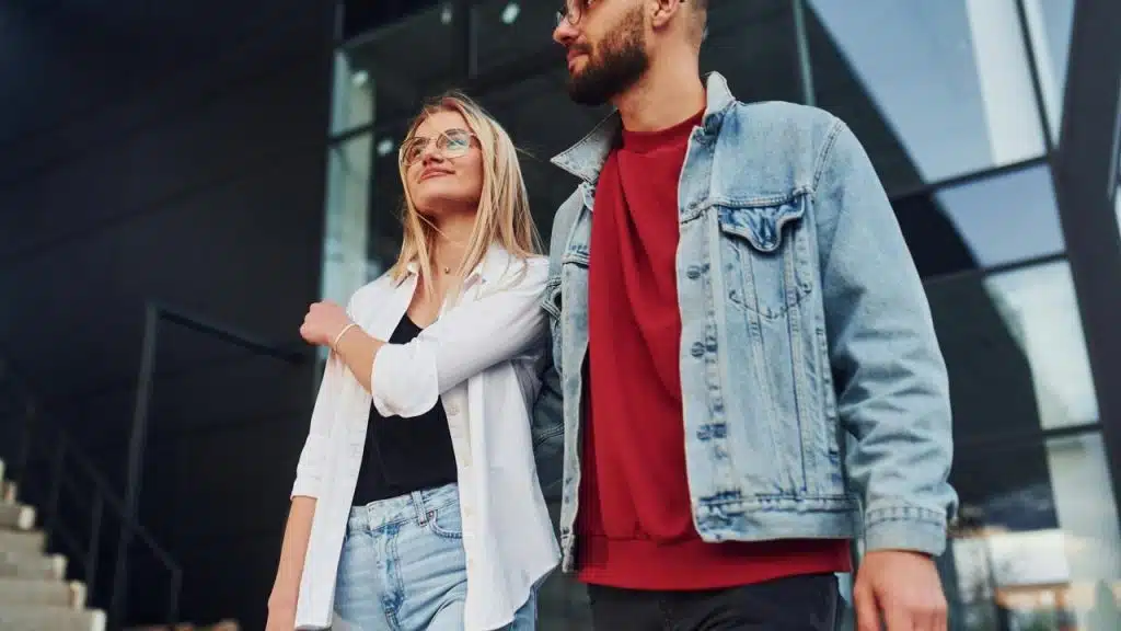 A couple walking together outside a modern building.