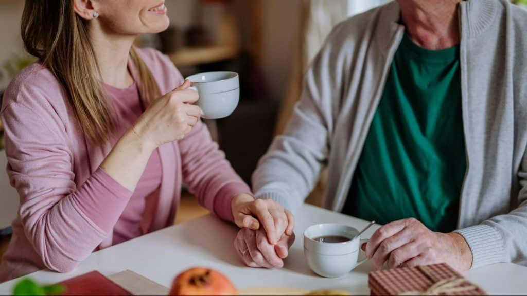 A man and woman holding hands together 