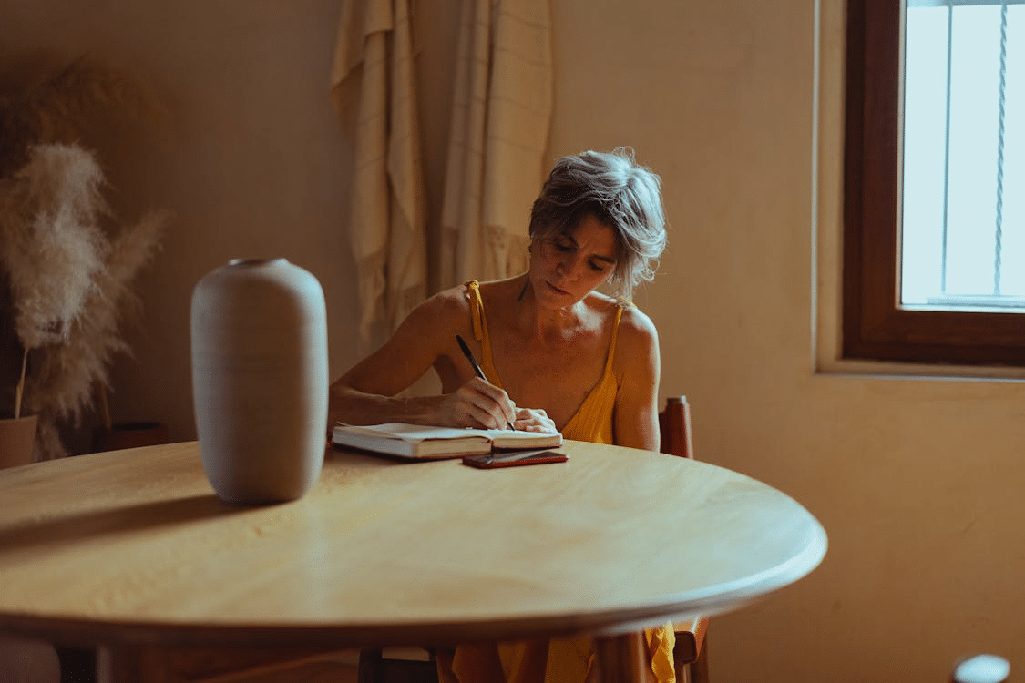 A woman writing at the table