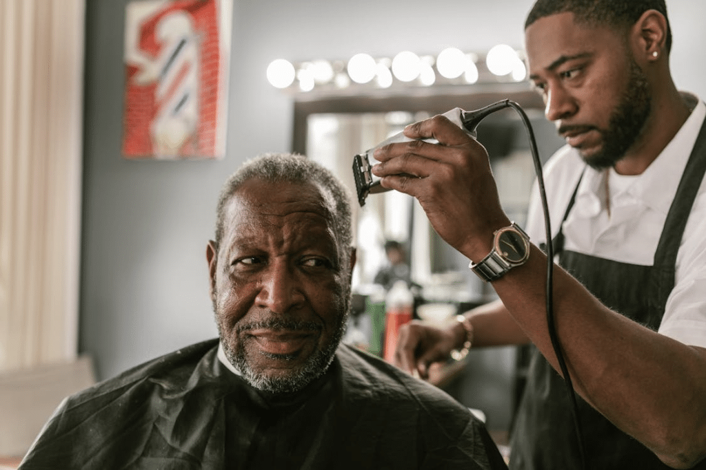 Elderly man in barbershop getting a haircut