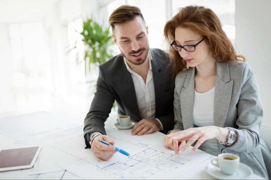 A man teaching something to woman