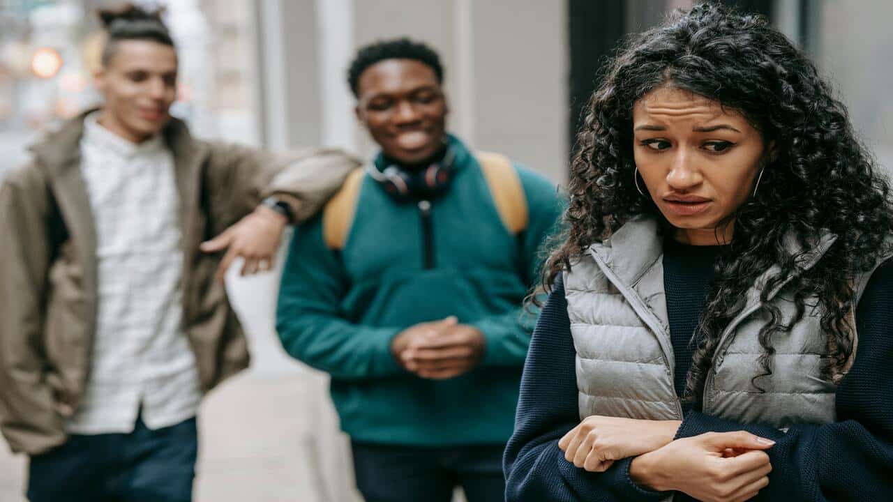 Two men making fun of a woman