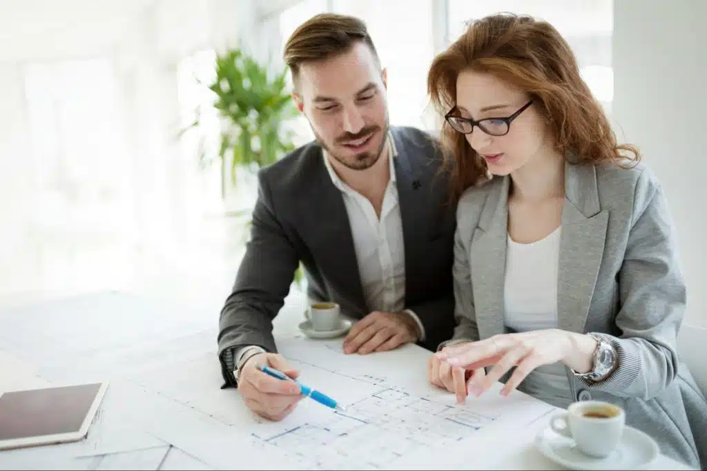 A man teaching something to woman