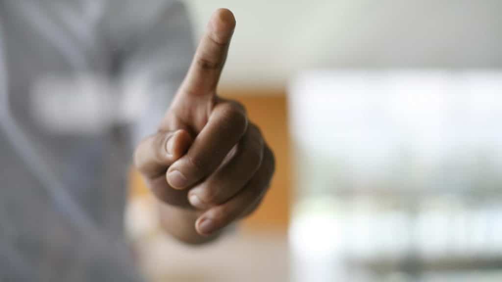 A close-up of a hand pointing forward.