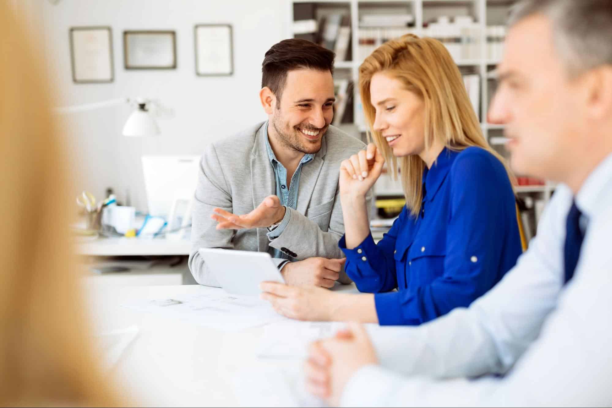 A man laughing with his colleagues