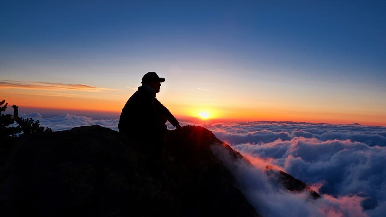 A man on top of a mountain