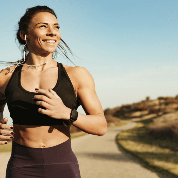 A woman smiling while jogging