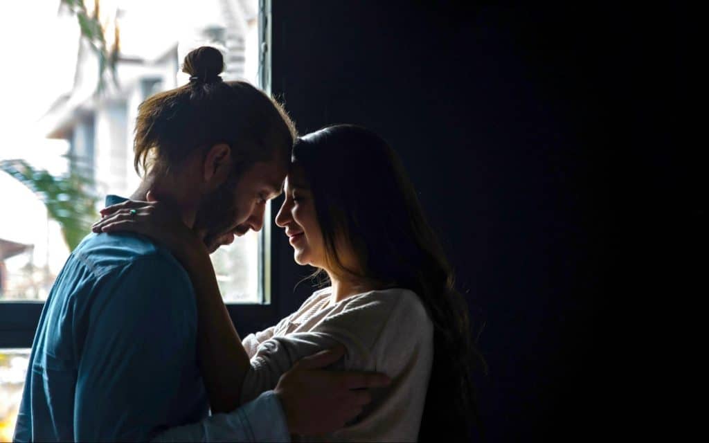 A man and woman at the bed