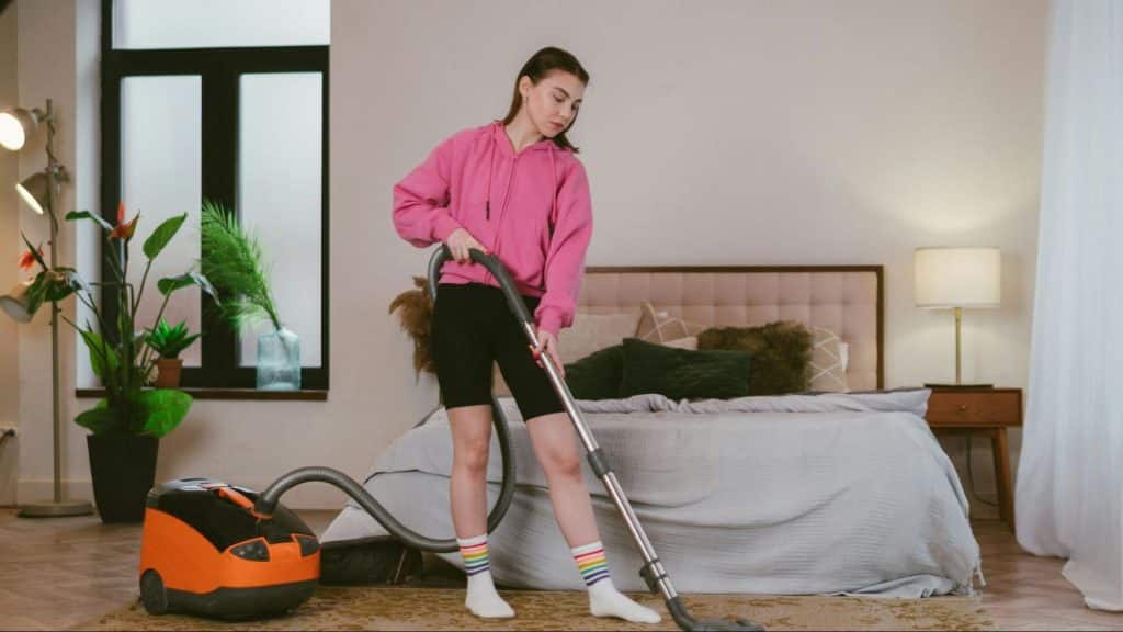 A woman vacuuming the floor