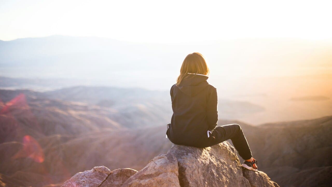 A woman on top of a mountain