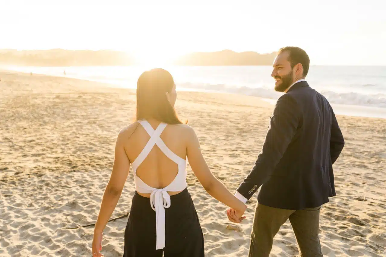 A couple walking on the beach during sunset