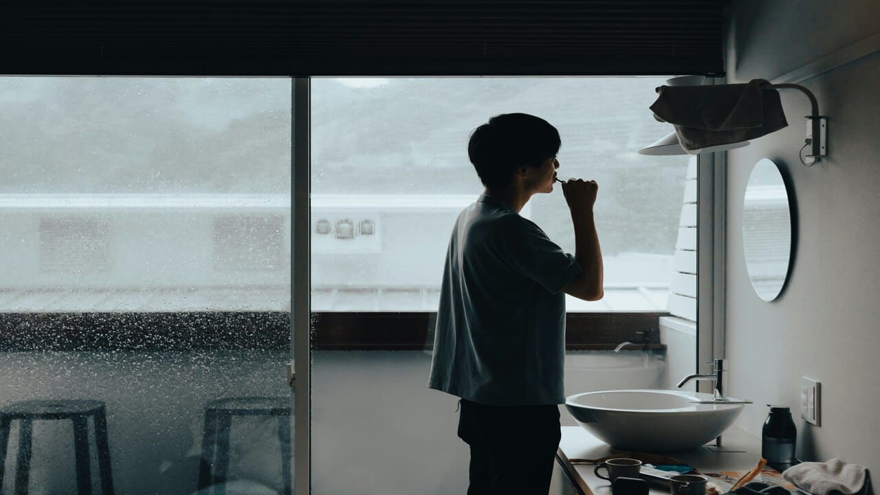 A man brushing his teeth alone