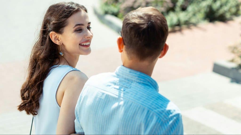 A woman smiling at the man