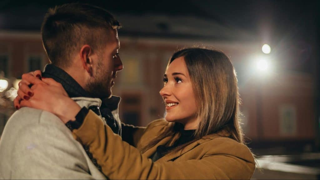 A woman looking at the man
