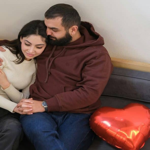 A couple cuddling at home