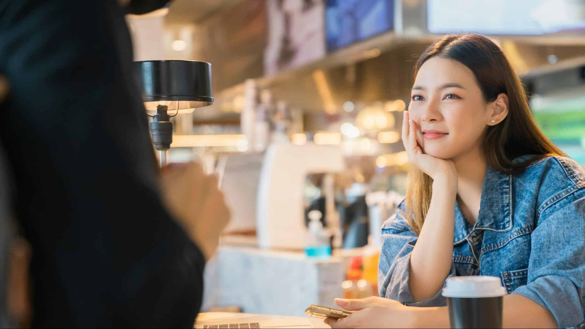 A woman smiling at the man