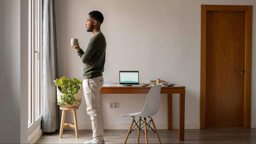 A man having a coffee while looking outside the window