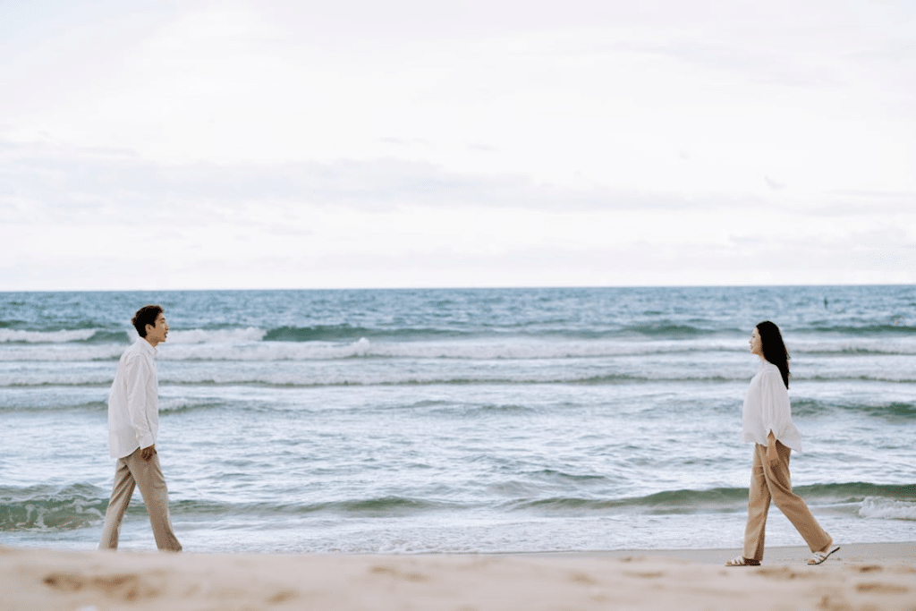 Man and Woman Walking on Beach